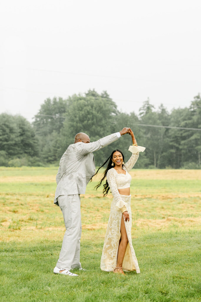 indian wedding style maine photographer colorful bride and groom dancing rain