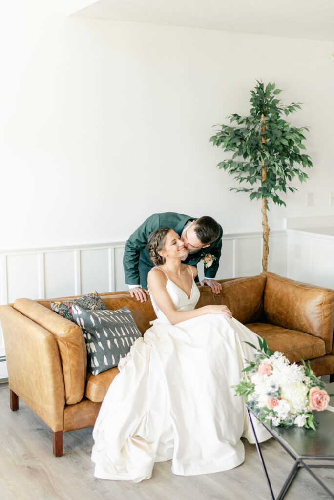 wedding couple sitting on couch in suite