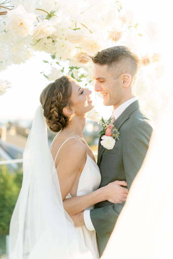 wedding couple bride and groom smiling golden hour portraits