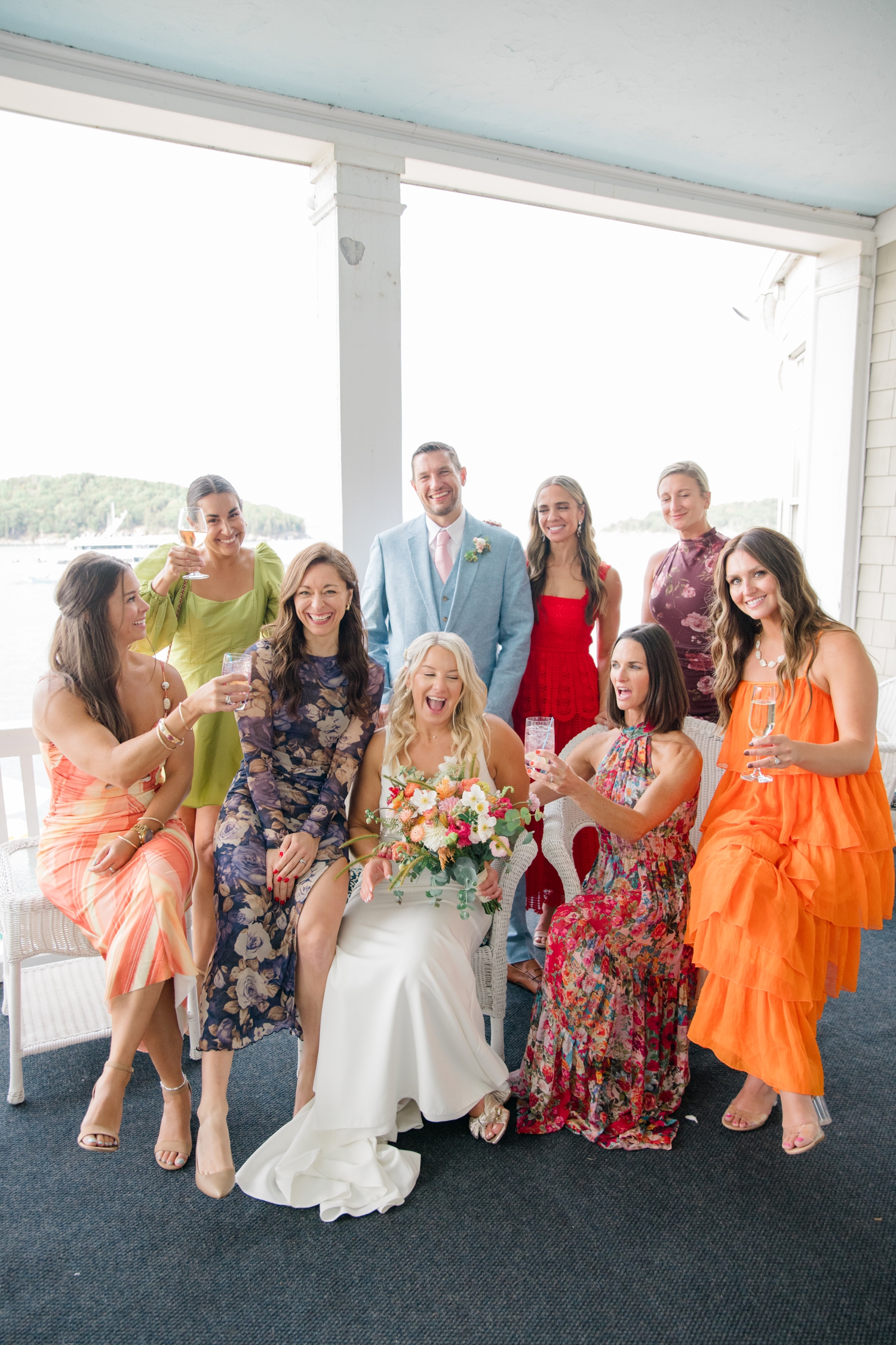 Vibrant fuchsia and yellow florals inspire a colorful coastal wedding in Maine with joyful chartreuse and orange details.