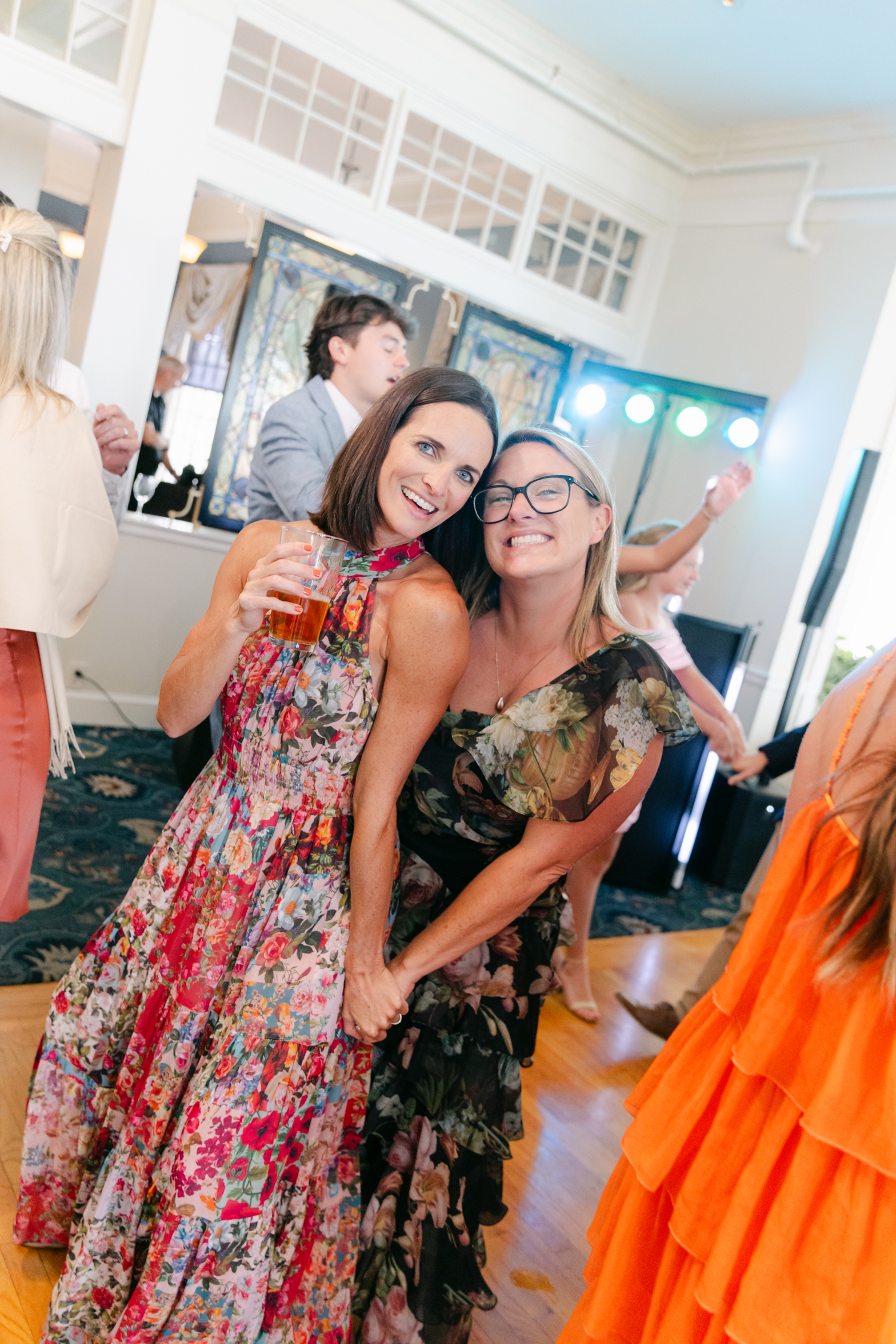 A vibrant guest dress code featuring colorful fuchsia, orange, and yellow tones perfect for a joyful coastal wedding in Maine.