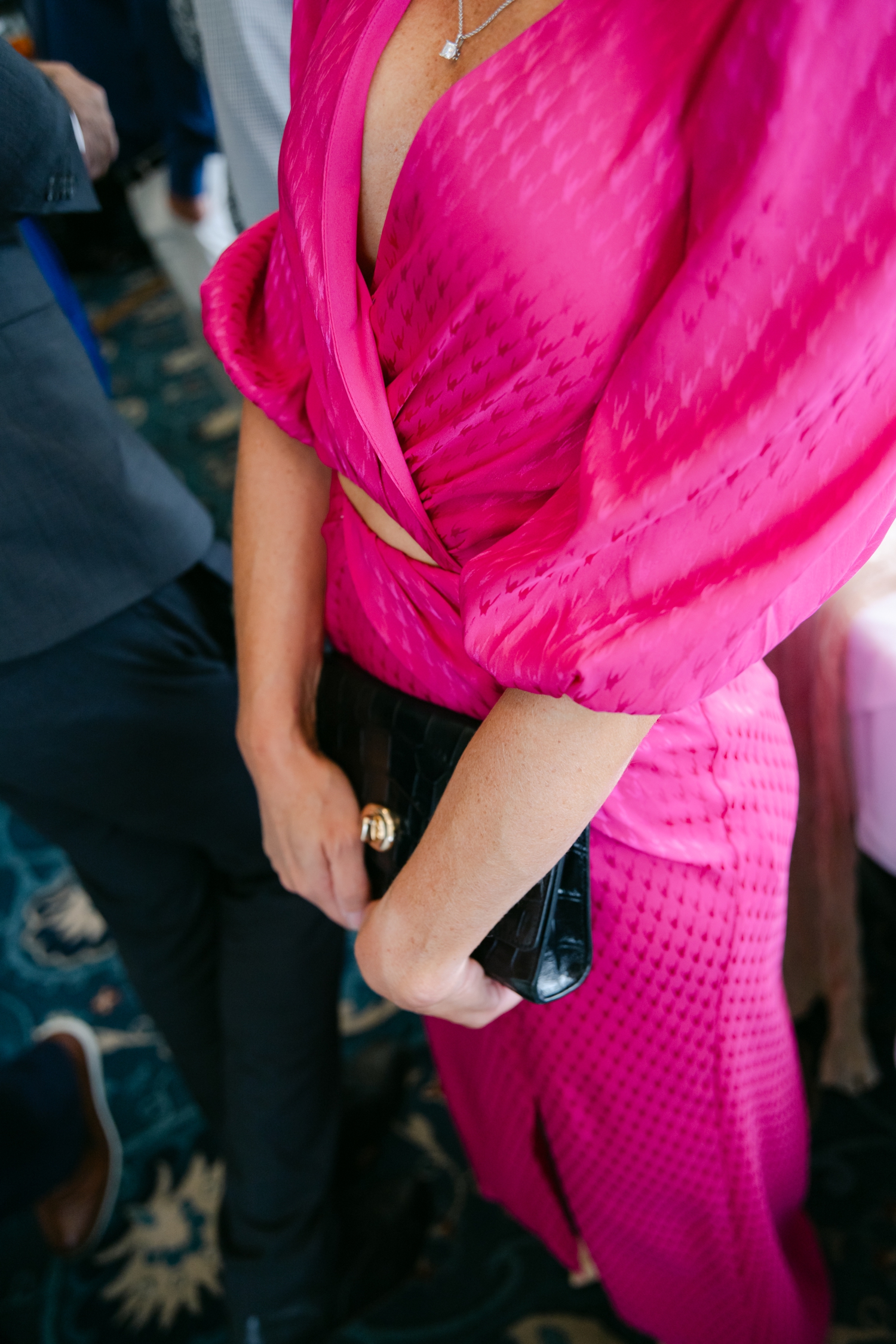 Colorful guest dress code ideas featuring vibrant orange and red attire that complement citrus florals at a joyful Maine wedding.