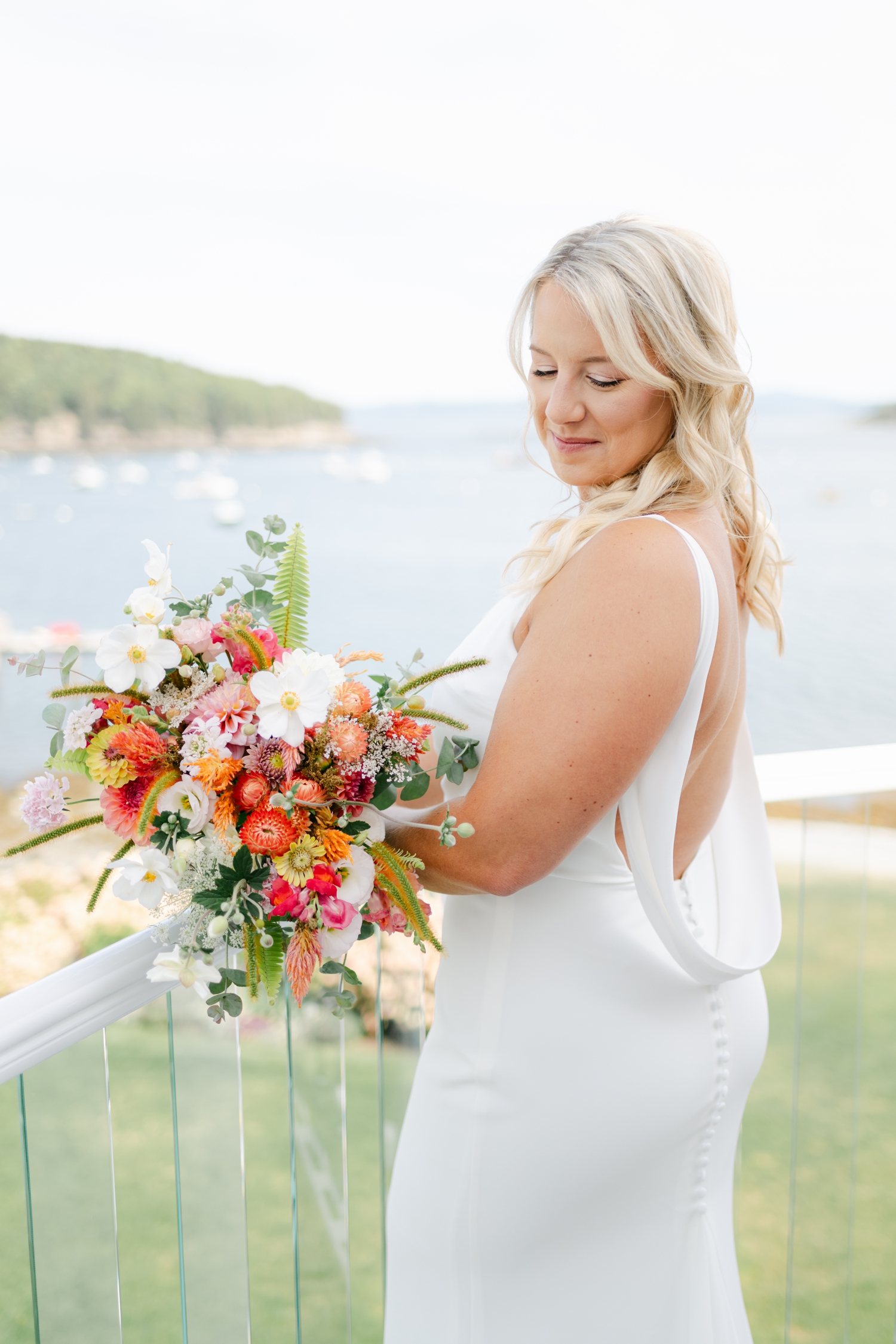 Vibrant citrus wedding florals in orange, pink, and chartreuse bringing joyful inspiration to a colorful coastal Maine celebration.