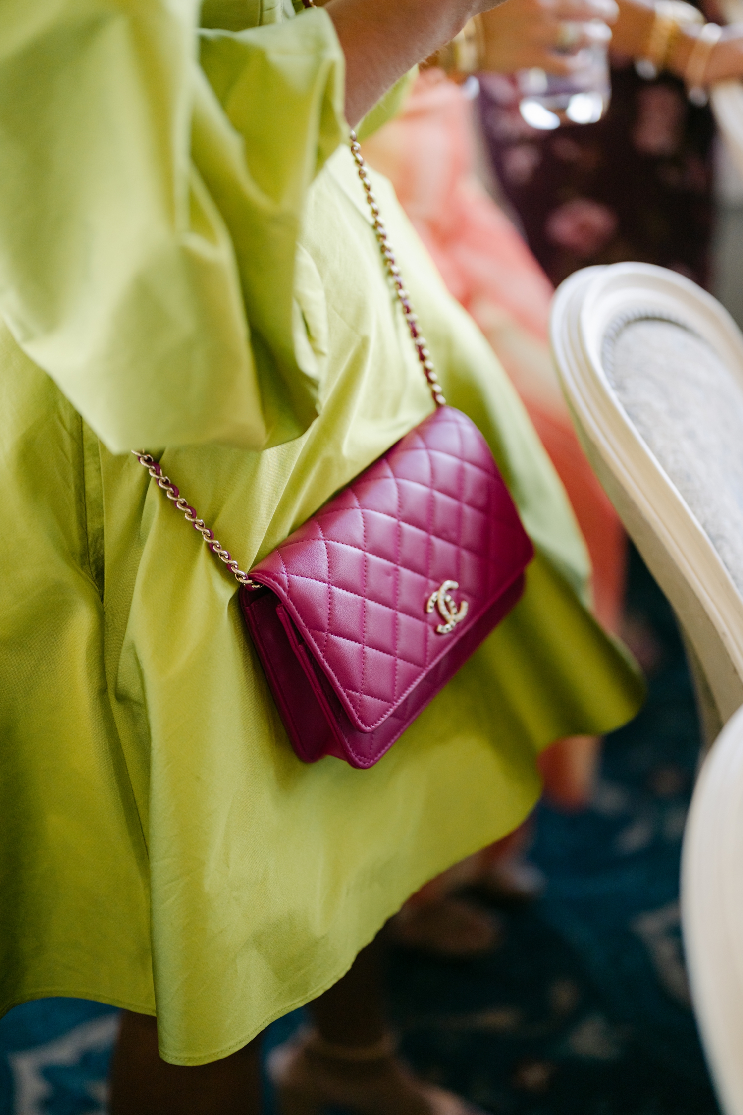 Colorful guest dress code ideas featuring vibrant orange and red attire that complement citrus florals at a joyful Maine wedding.