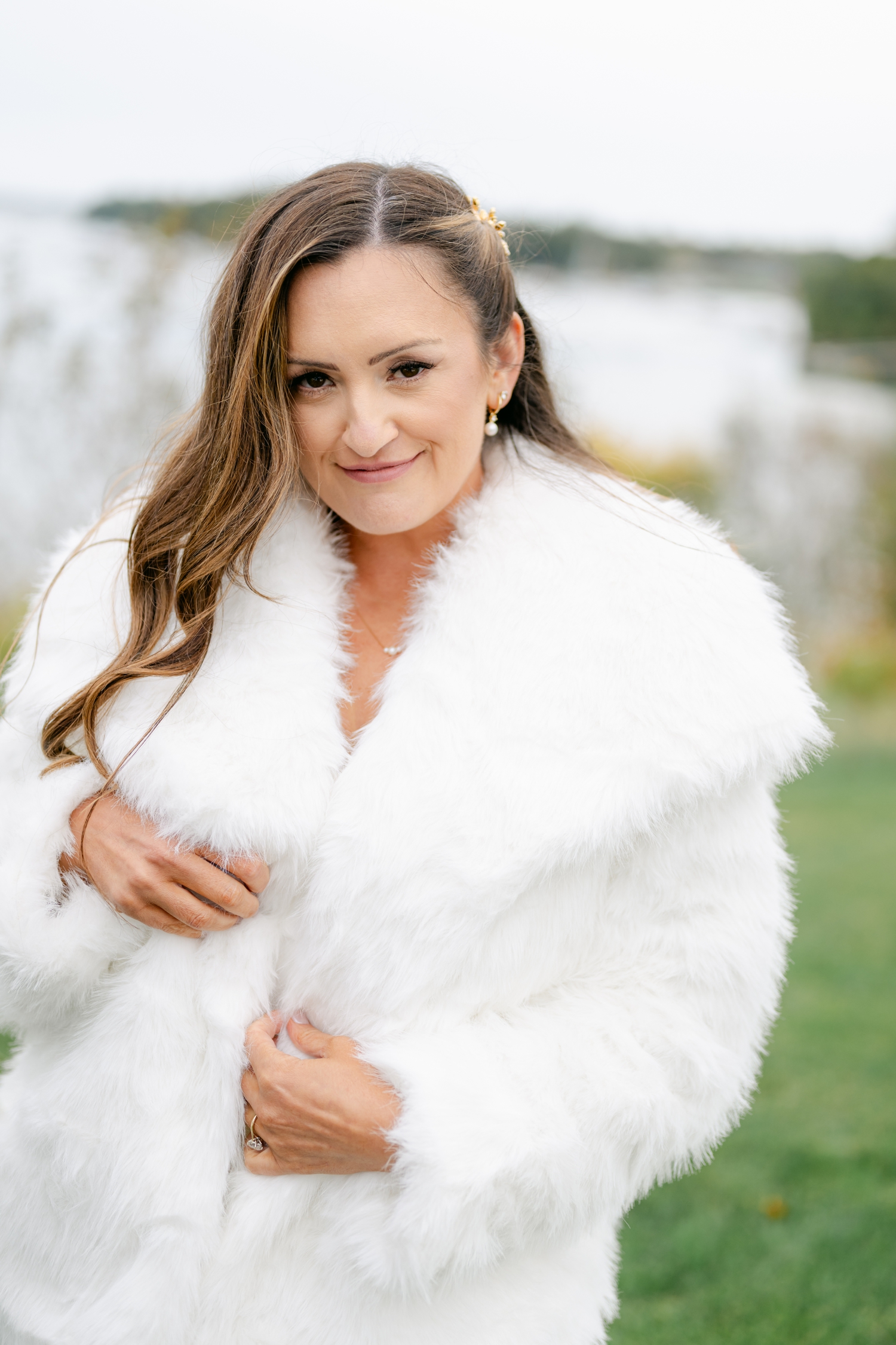 Bride wrapped in a white coat outside of Asticou Hotel Wedding.