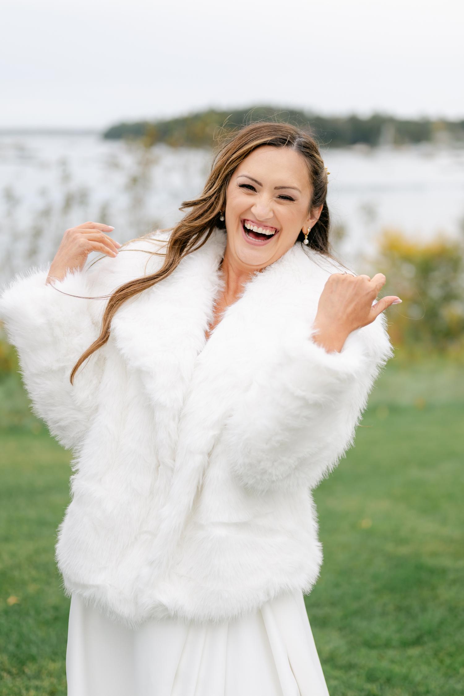Bride wrapped in a white coat outside of Asticou Hotel Wedding.