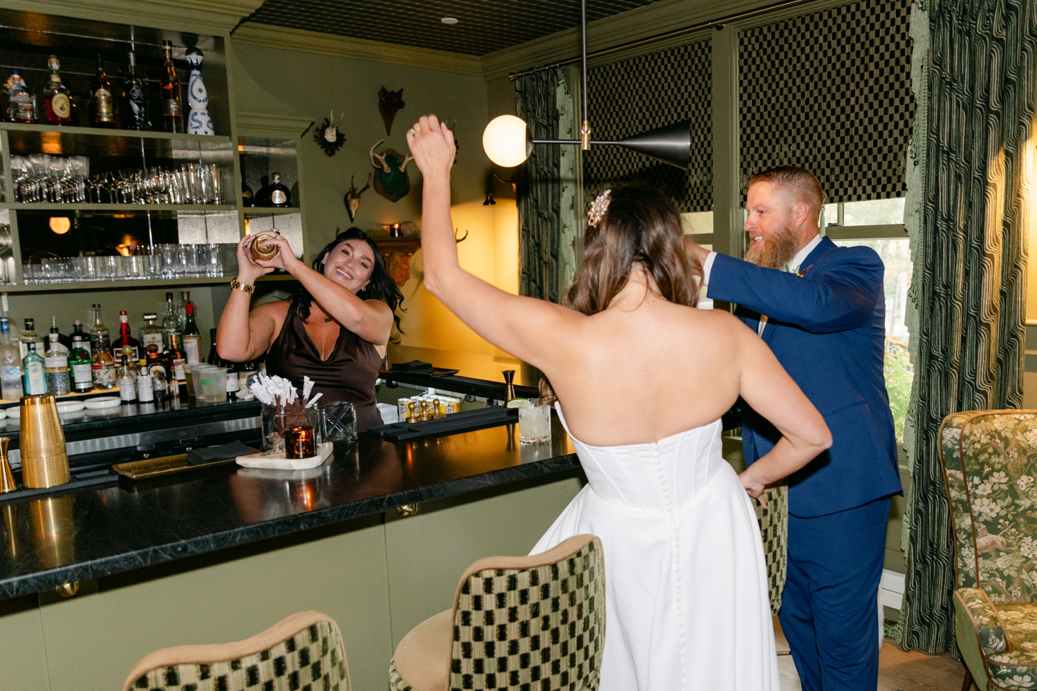 Bride and Groom celebrating inside the bar at the Asticou Hotel during their cozy fall micro-wedding.