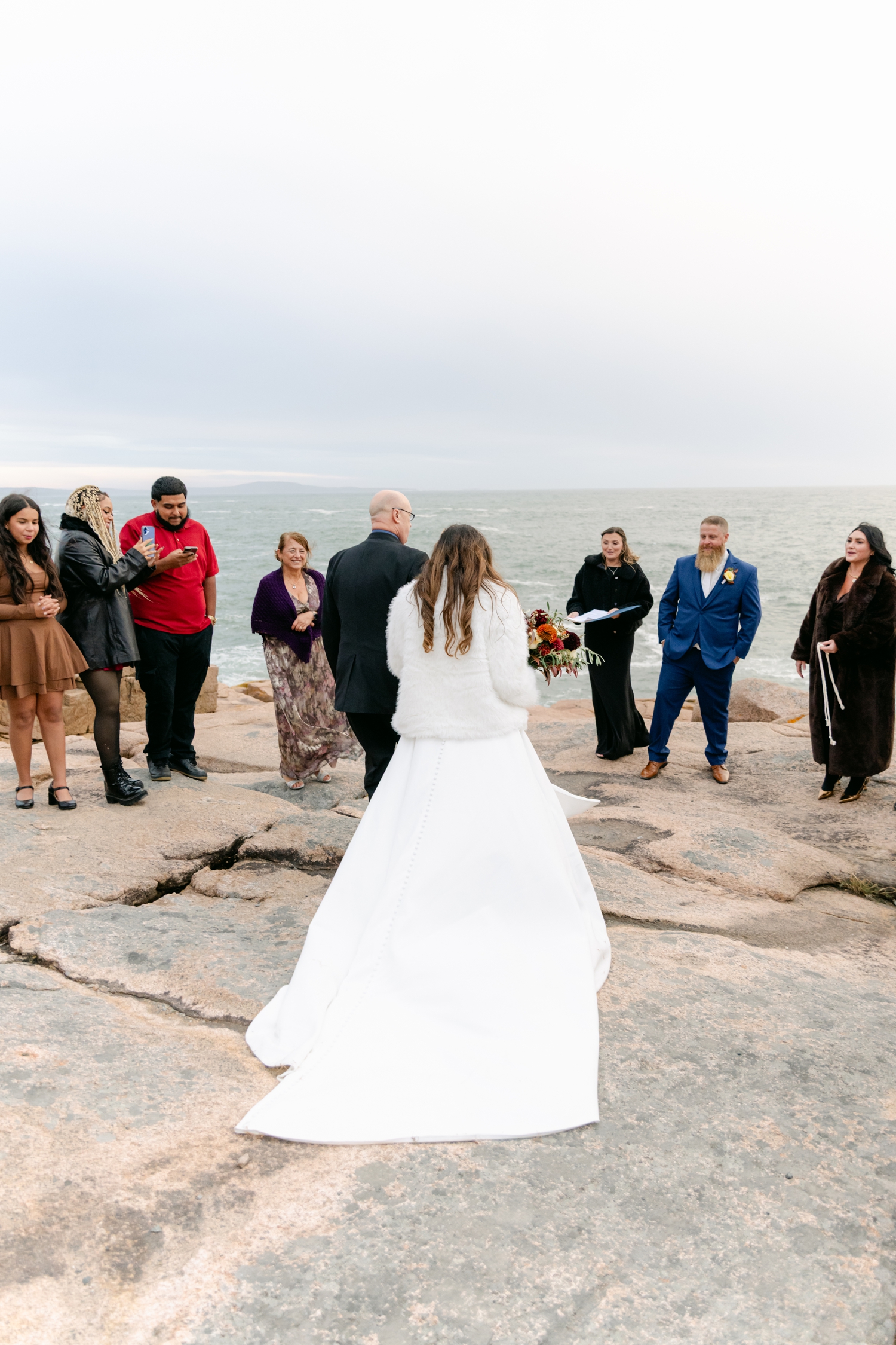 Family gathering around the Bride and Groom during their intimate elopement ceremony in Acadia National Park.