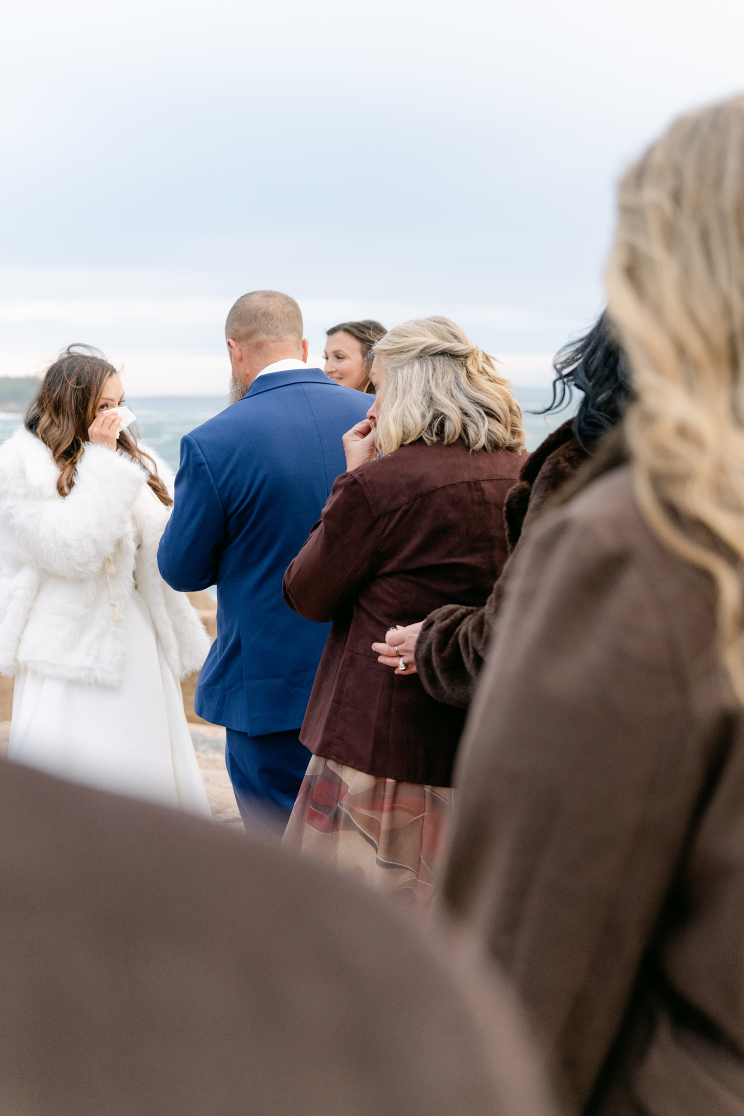 Family gathering around the Bride and Groom during their intimate elopement ceremony in Acadia National Park.