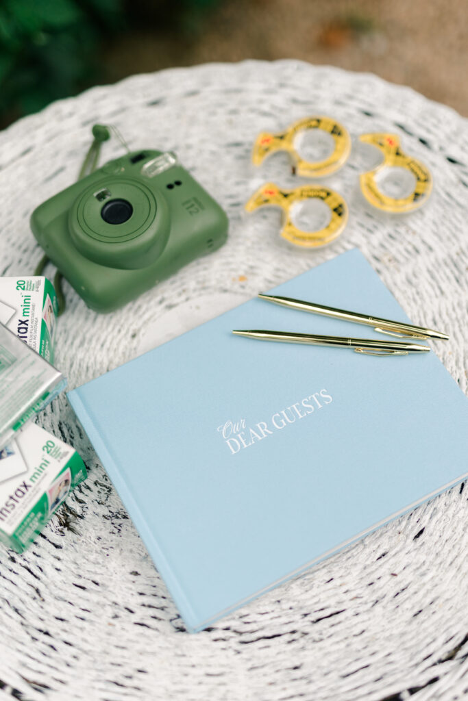 Blue polaroid wedding guest book at cocktail hour 