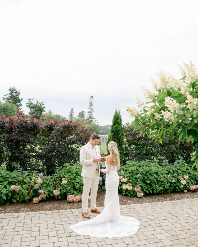 Madison and Eli exchanging private vows before their coastal wedding ceremony at The Bar Harbor Club in Maine, soaking in a calm and meaningful moment together.