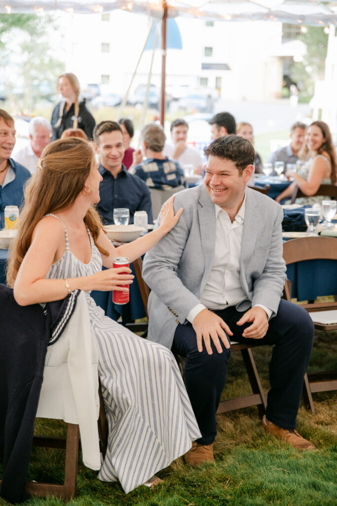 wedding guests and couple laughing and connecting at a rehearsal dinner in Bar Harbor Maine